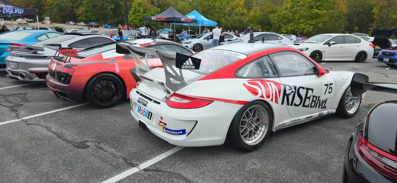 The paddock at the meet — Cup 911 and R8 LMS side by side