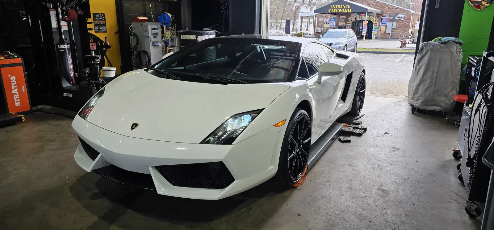 Nitrogen tire fills on site at Prestige Performance Center — Lamborghini beside the tire equipment