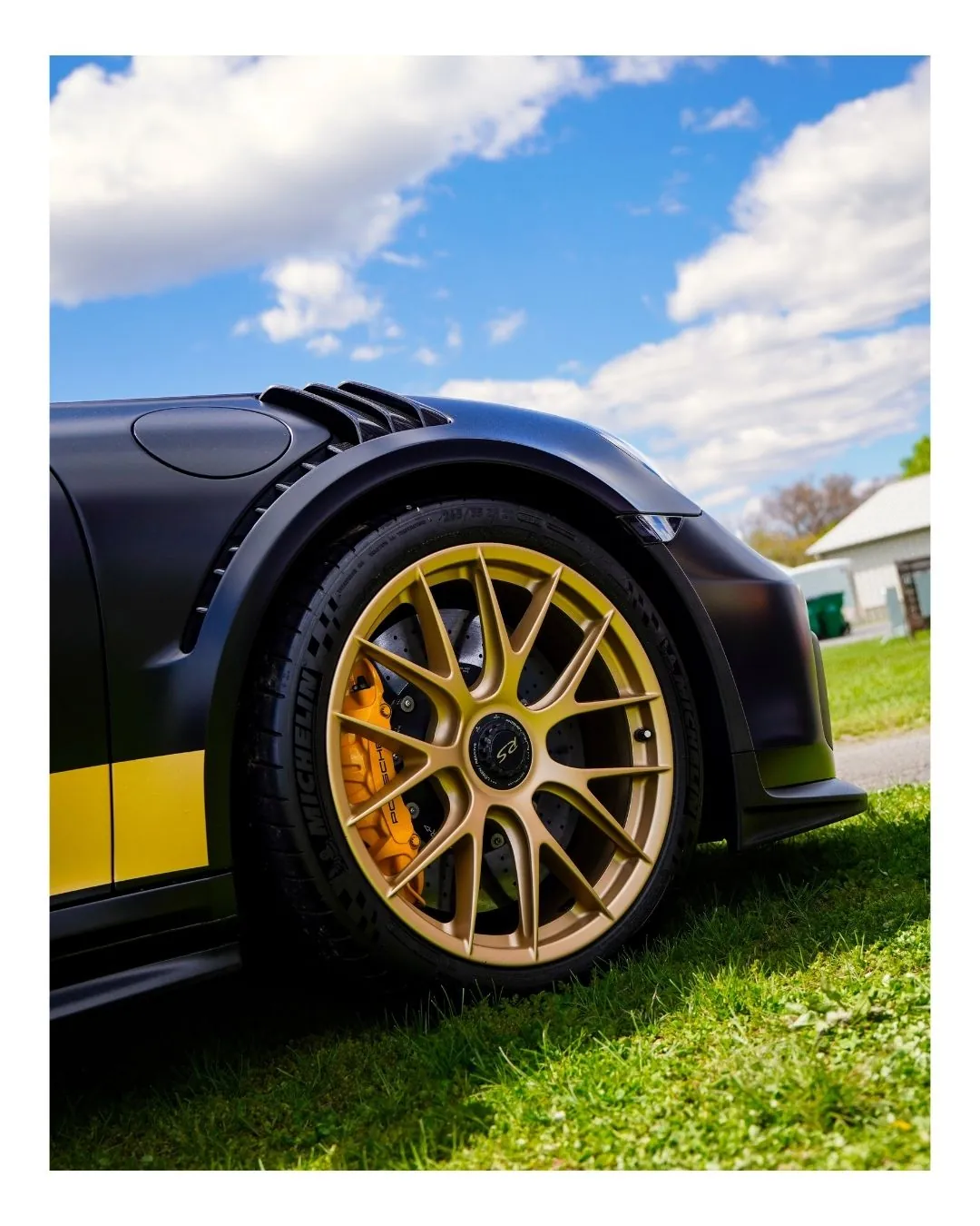 GT3 RS ceramic brakes behind gold RS wheels — performance brake work at Prestige Performance Center