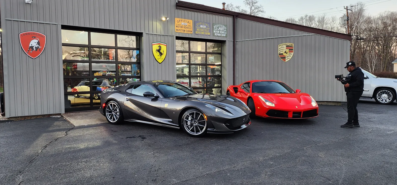 Ferrari 812 GTS and Ferrari 488 in front of Prestige Performance Center under the Lamborghini, Ferrari, and Porsche shields, Hopewell Junction NY