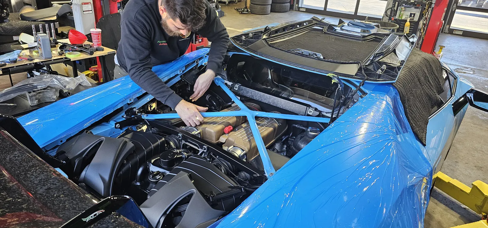 Technician servicing the V10 in a Lamborghini Huracan Performante at Prestige Performance Center