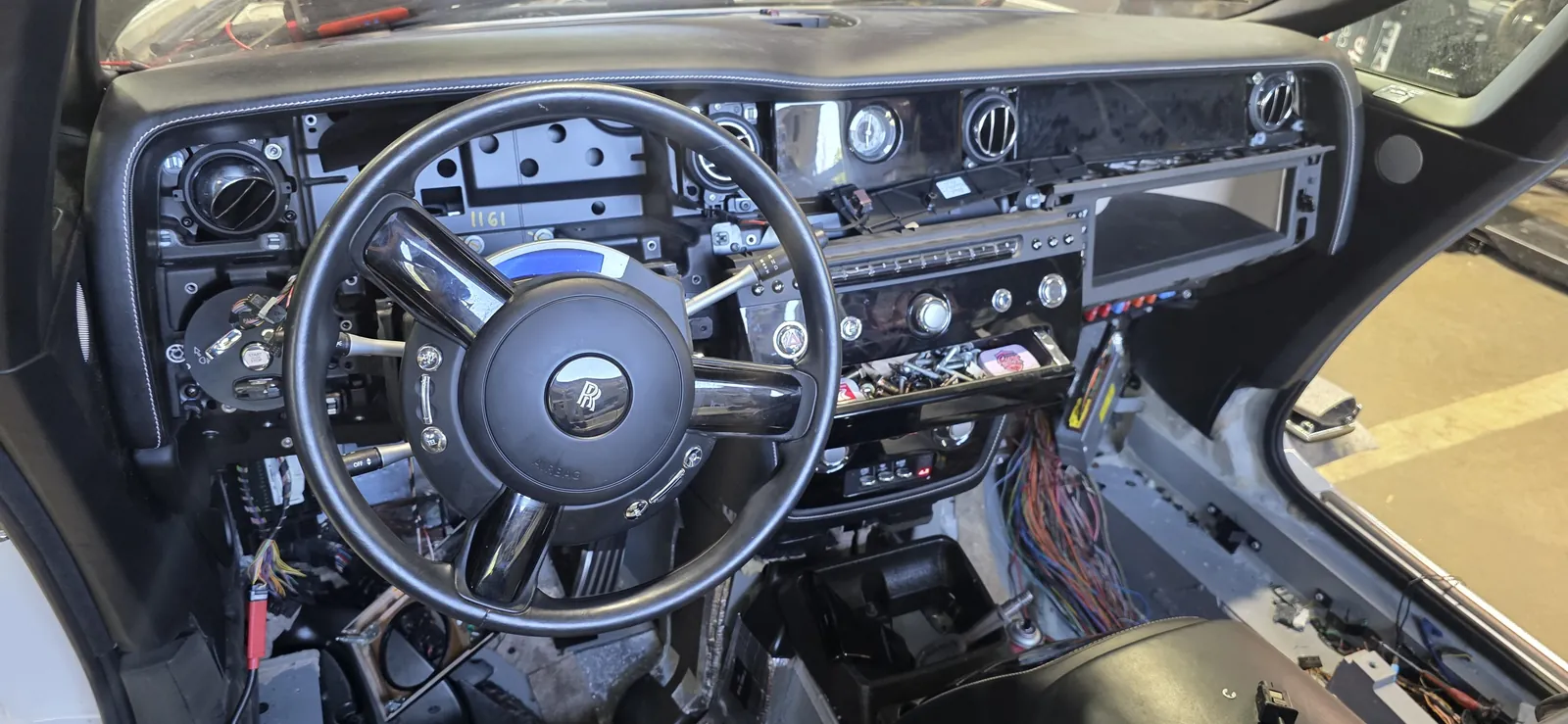 Rolls-Royce dashboard opened for module-level electronics work at Prestige Performance Center
