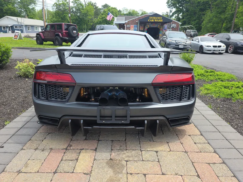 The shop's twin-turbo Audi R8 — turbos visible through the rear grille, gold wheels, carbon aero