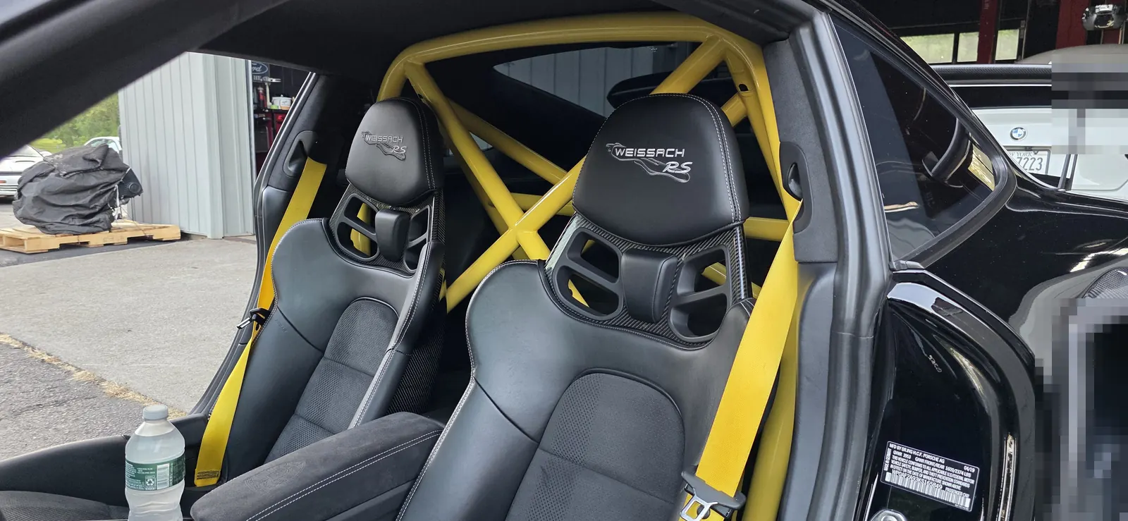 Yellow Clubsport cage cross-bracing and harnesses in a GT2 RS Weissach at Prestige Performance Center