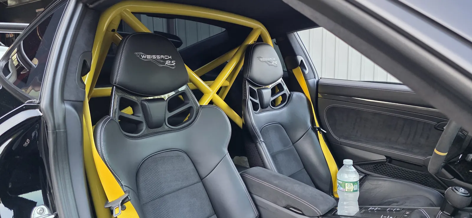 Porsche GT2 RS Weissach interior with yellow Clubsport roll cage and harnesses — installed at Prestige Performance Center