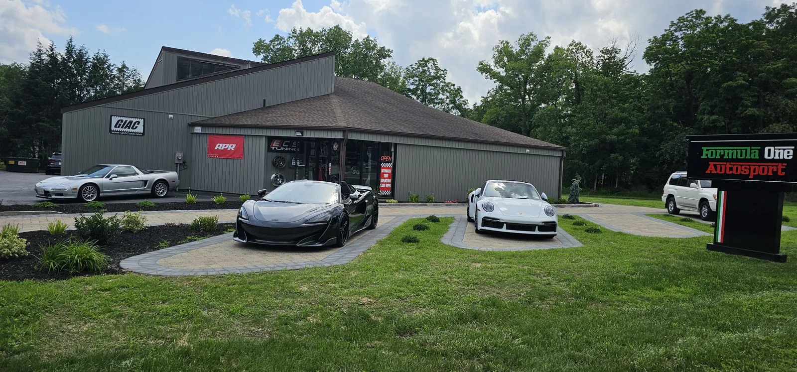The shop during the Formula One Autosport years — NSX, McLaren and 911 Turbo S out front