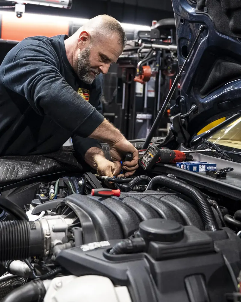 Technician servicing a Porsche Panamera