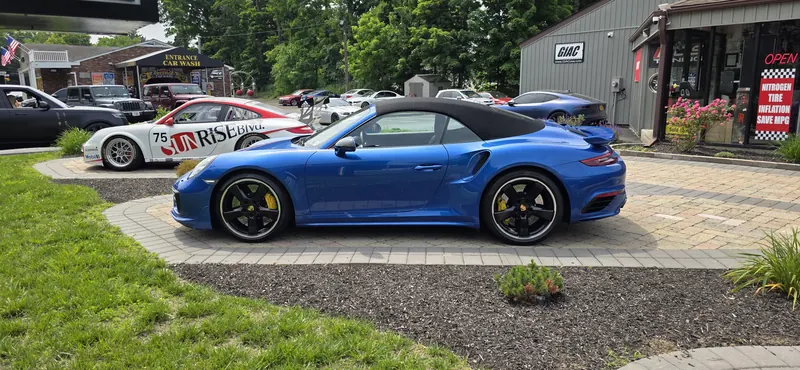 Sapphire blue 991 Turbo S Cabriolet out front, the Cup car behind